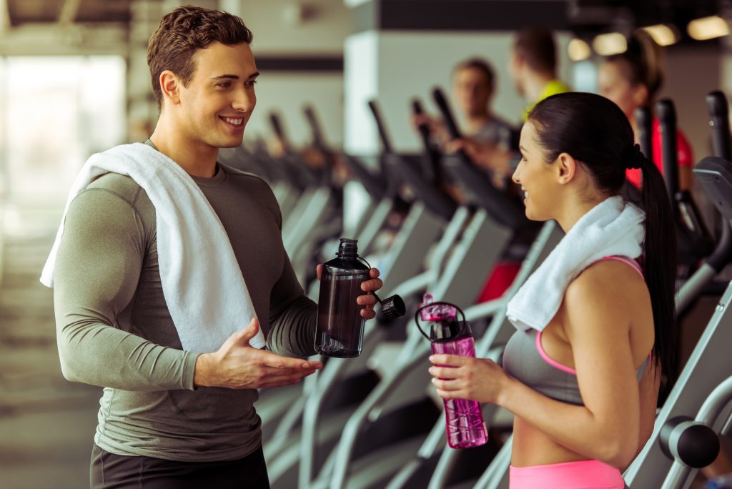 man and woman talking at the gym