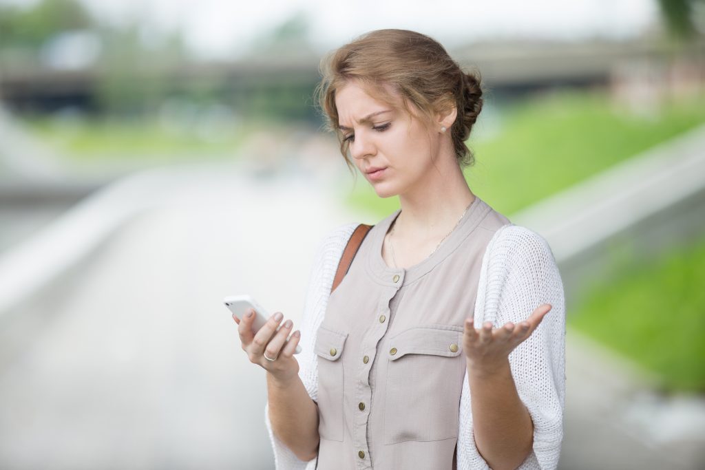 woman texting confused