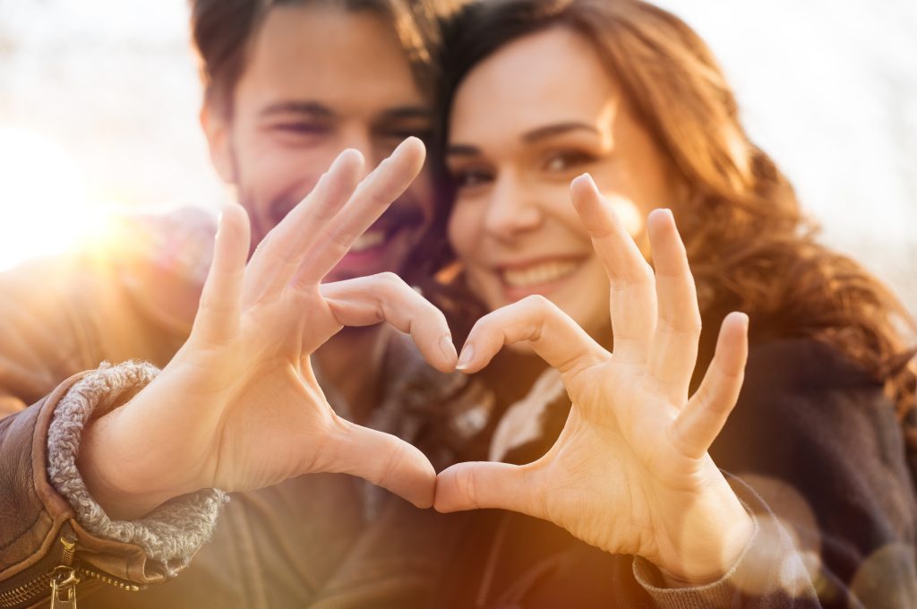 couple making heart shape with their hands