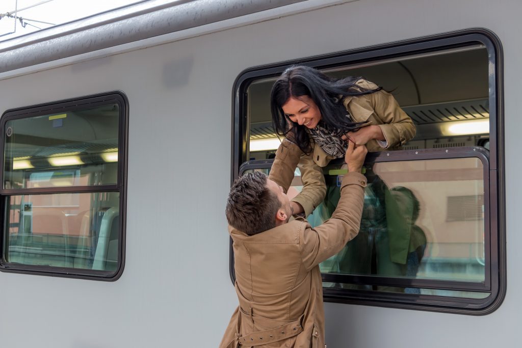 couple saying goodbye on train