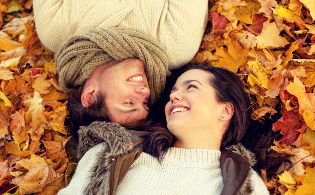couple laying on leaves