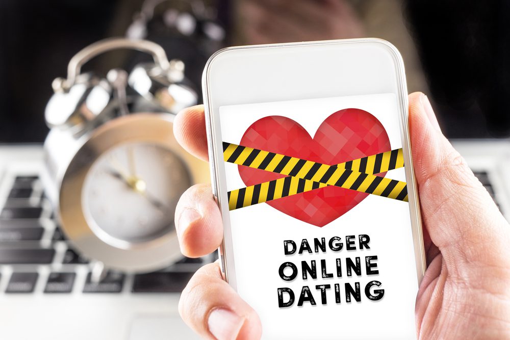 phone screen with warning about online dating