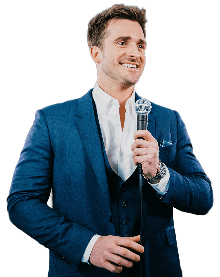 Matthew Hussey speaking and holding microphone